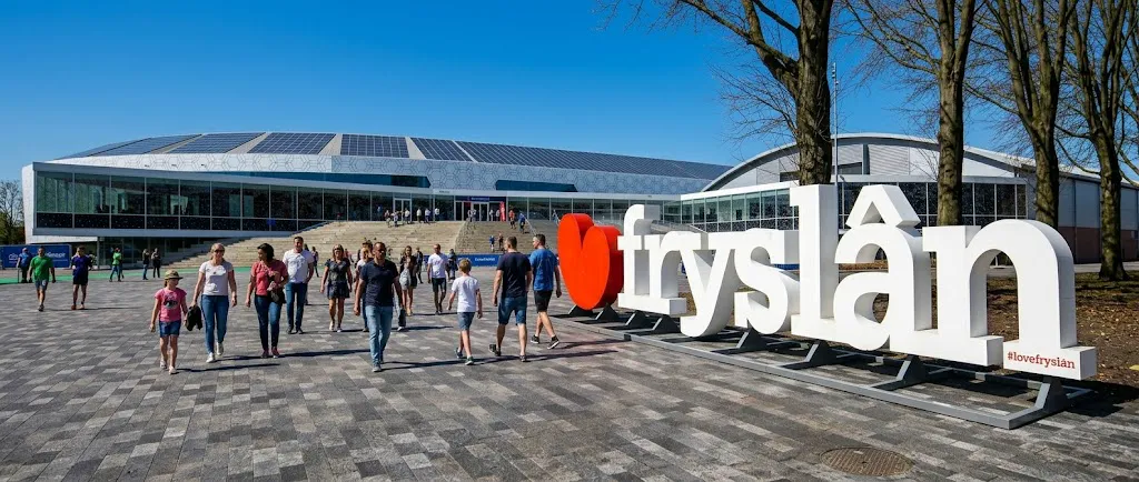 Visitors walking toward Sportstad Heerenveen past the I Love Fryslan sign